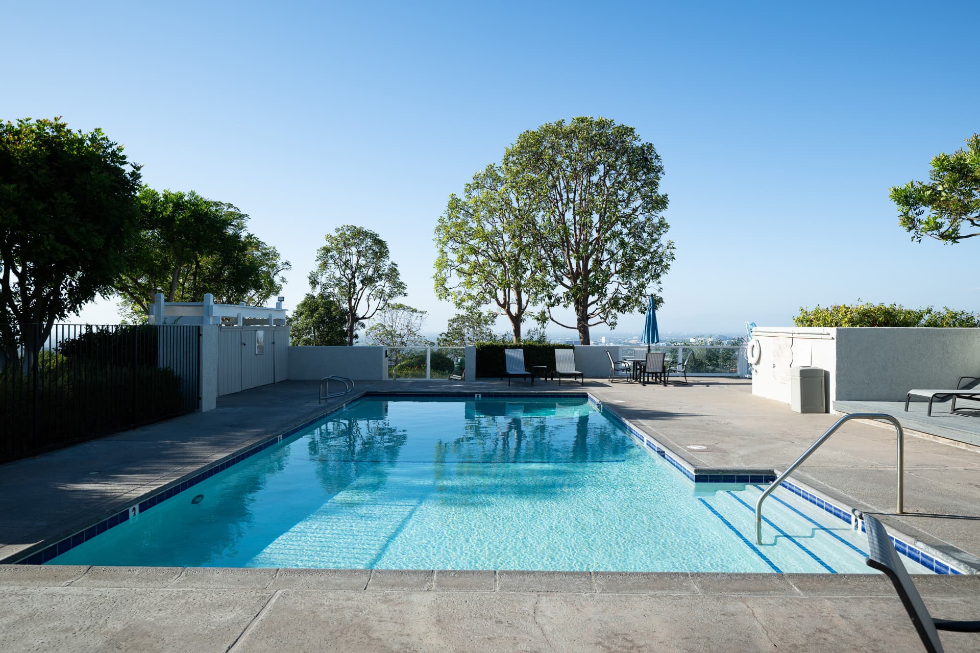 Community pool with loungers and mountain views