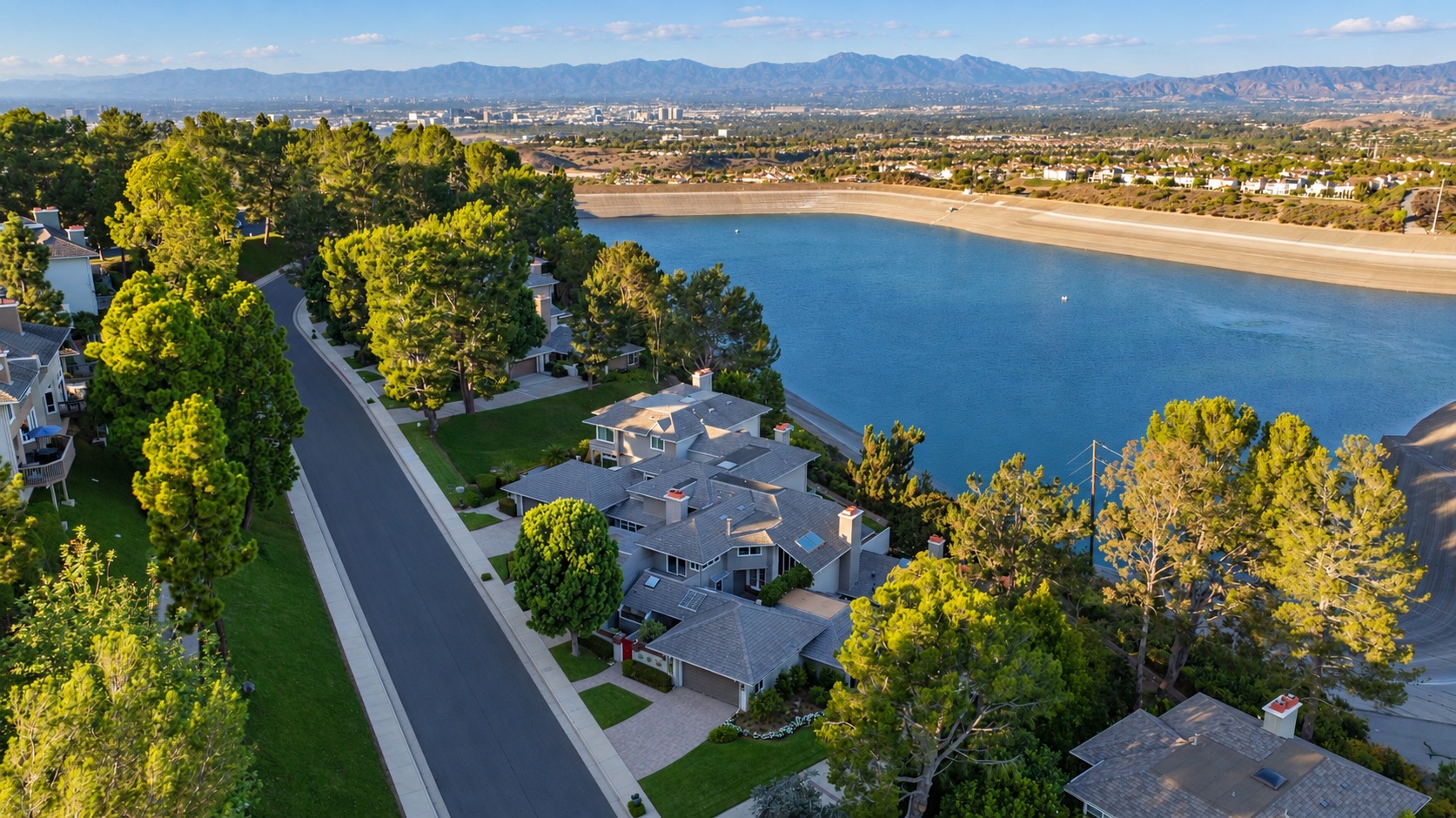 Aerial view of the reservoir and Harbor Ridge Crest tree-lined street