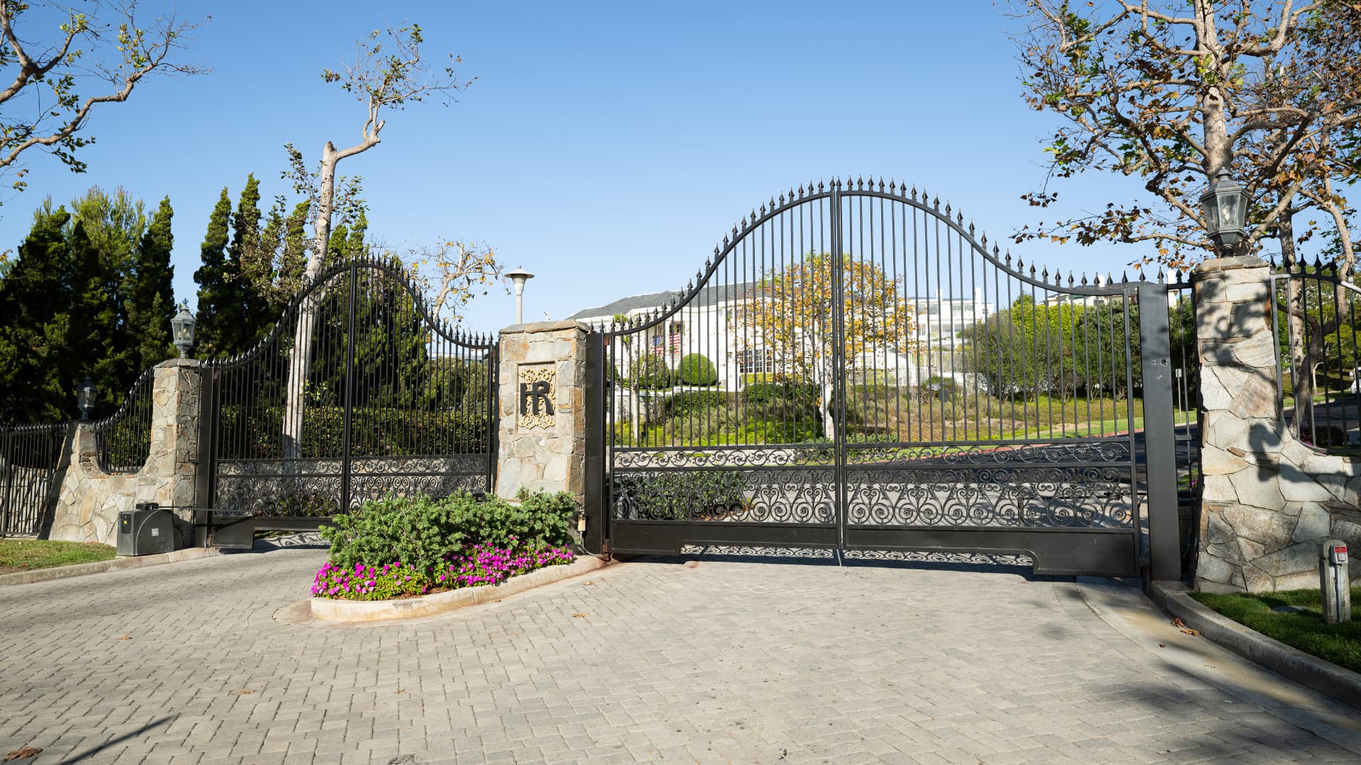 Ornate iron entry gates with the Harbor Ridge monogram and stone pillars
