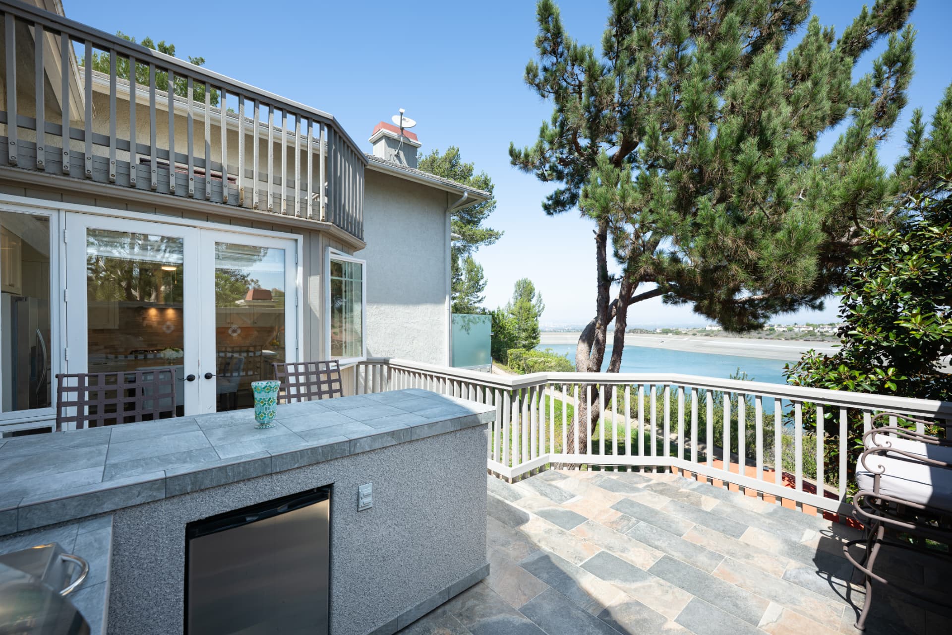 Outdoor kitchen and serving bar framed by the reservoir view
