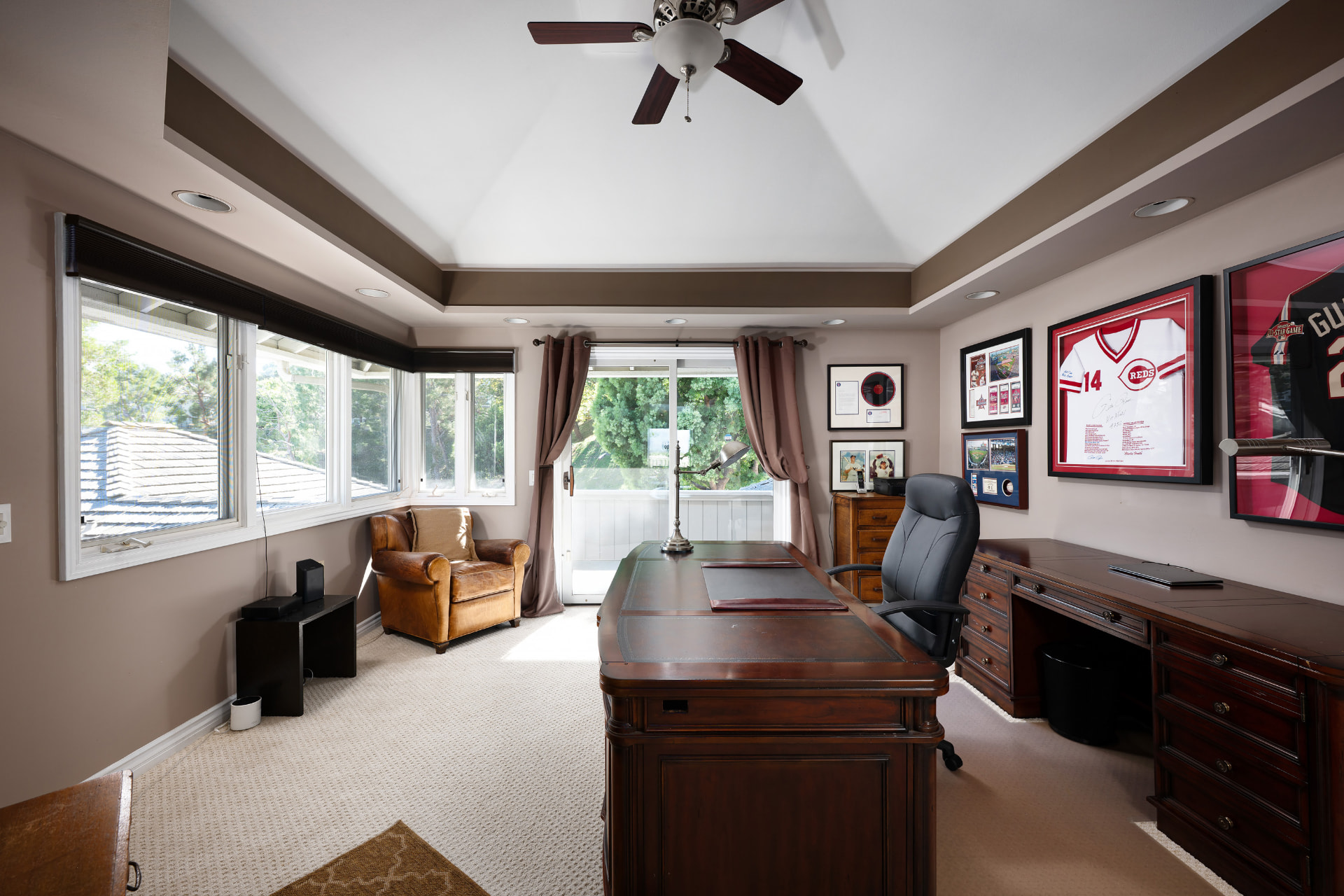Home office with built-in desk and framed sports memorabilia