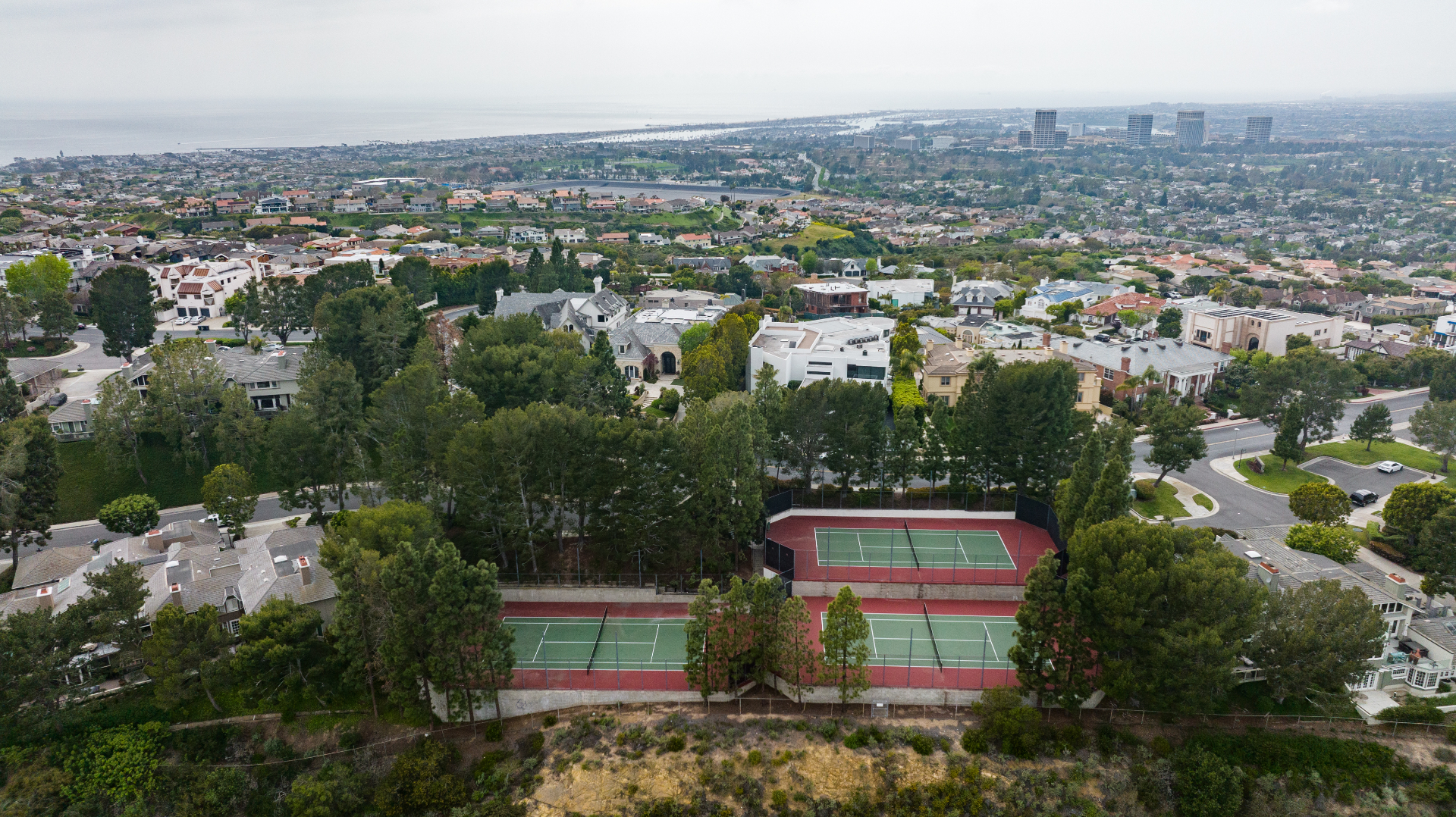 Harbor Ridge community tennis courts and hillside